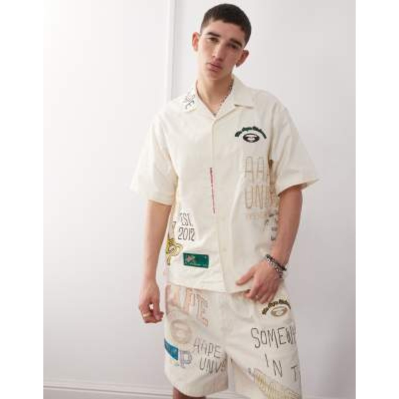 Aape By A Bathing Ape multi logo college short sleeve shirt in beige