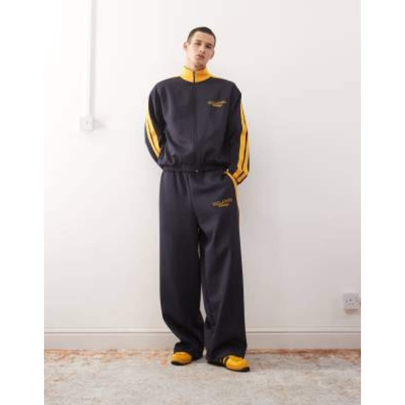 Reclaimed Vintage tracksuit set in navy with side stripe